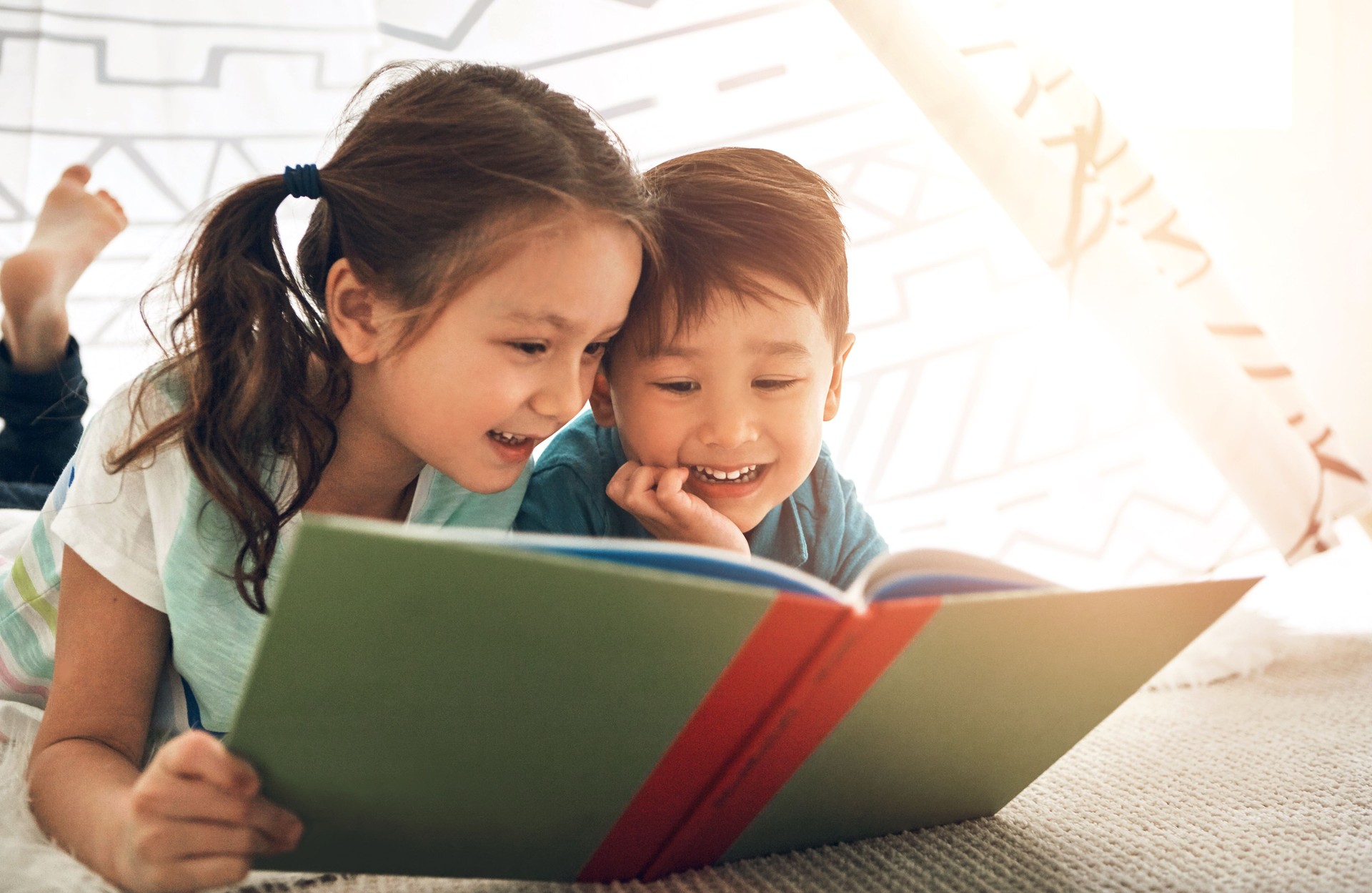 Children, reading and siblings in home with book for story time, education and literature adventure for storytelling. Boy, girl and together on floor for fantasy or bonding, learning and development.